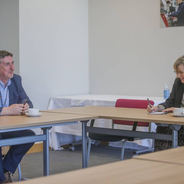 Welsh Language Commissioner Efa Gruffudd Jones talks to Grŵp Llandrillo Menai's Chief Executive Officer Dafydd Evans at Coleg Llandrillo