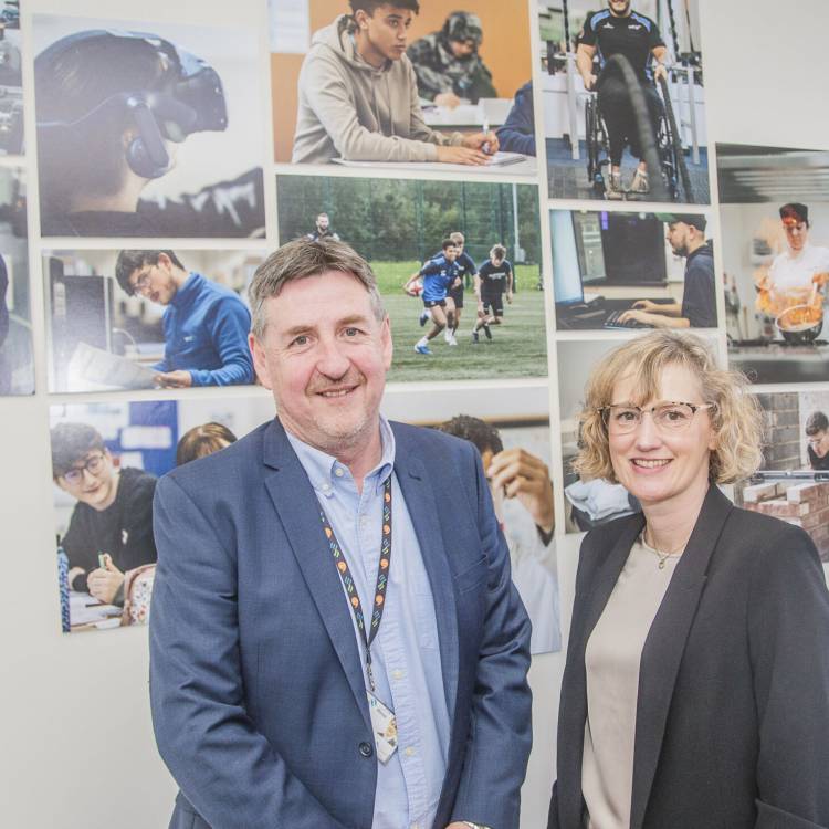 Welsh Language Commissioner Efa Gruffudd Jones with Grŵp Llandrillo Menai's Chief Executive Officer Dafydd Evans at Coleg Llandrillo