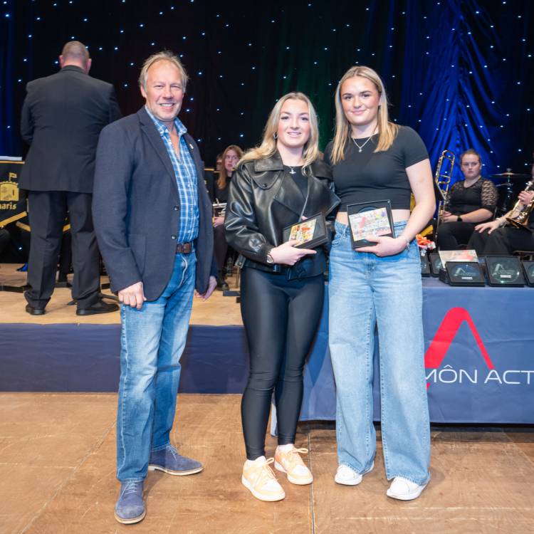 Casi Evans and Catrin Stewart are presented with the Junior Sportswoman of the Year award at the Môn Actif Sports Awards 2023