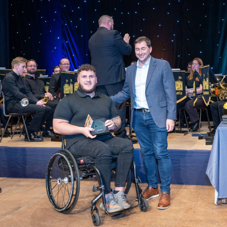 Kieran Jones being presented with the Personal Achievement award at the Môn Actif Sports Awards 2023