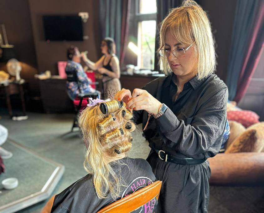 Elle Maguire cutting a client’s hair at her salon, The Hair Bar in Bangor