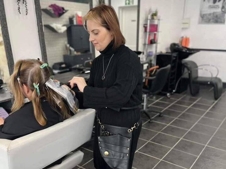 Elle Maguire cutting a client’s hair at her salon, The Hair Bar in Bangor