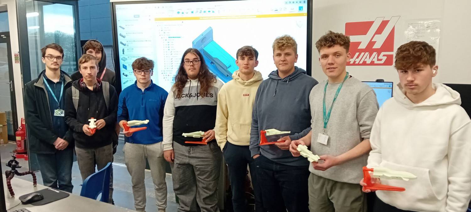 Coleg Meirion-Dwyfor students with their F1 in Schools designs at Coleg Menai’s engineering centre in Llangefni