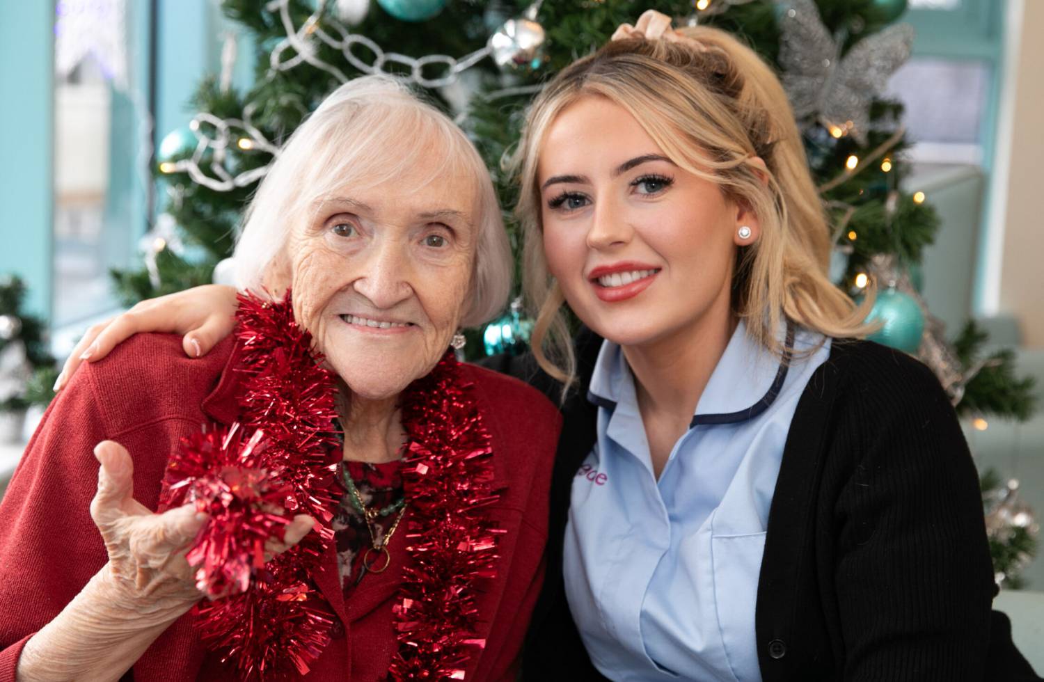 Clinical Care Practitioner and former Coleg Menai student Erin Jones with resident Eve Flint at Pendine Park’s Bryn Seiont Newydd care home