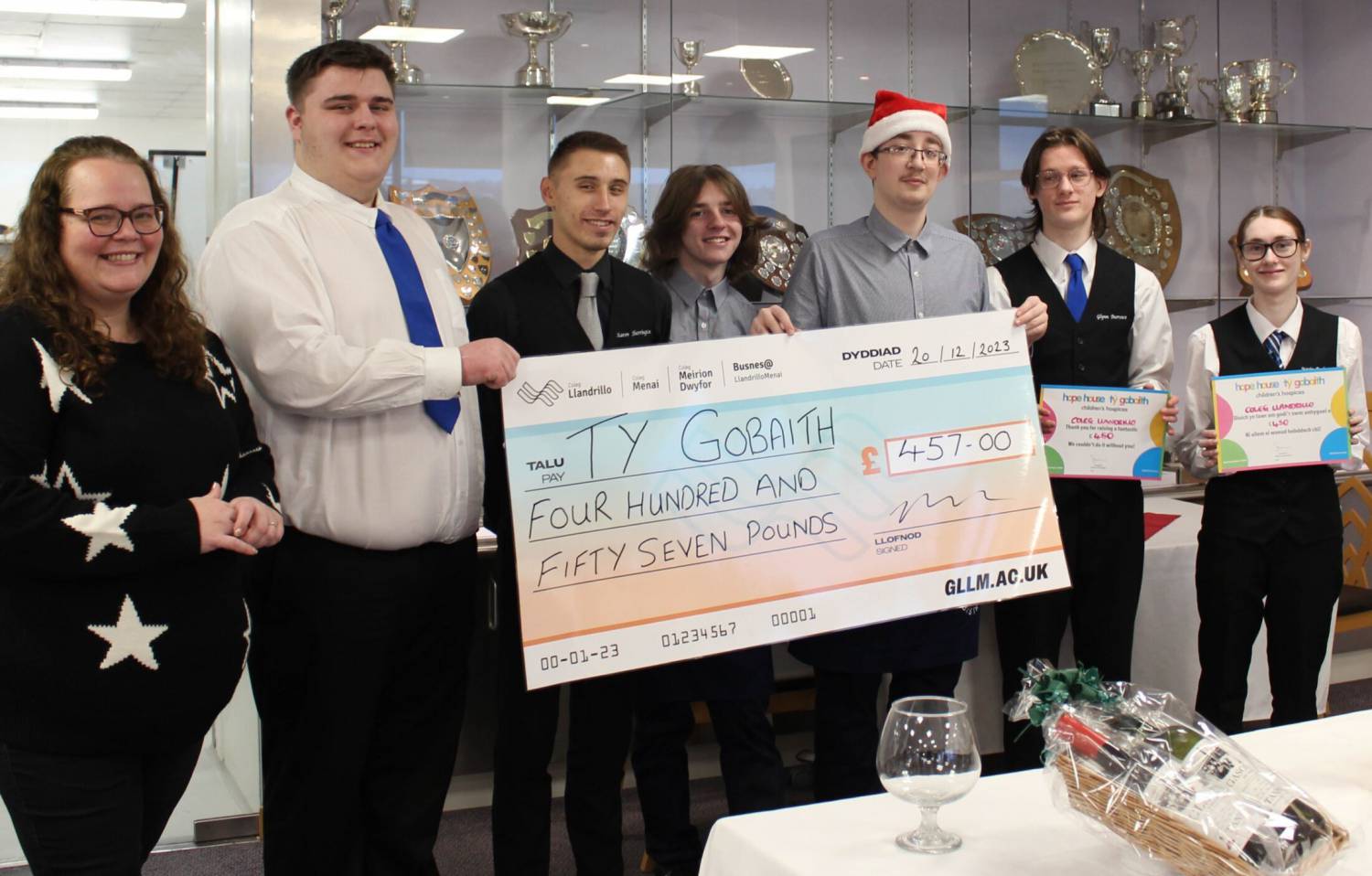 Coleg Llandrillo students holding a cheque for Tŷ Gobaith after a fund-raising meal was held at the Orme View restaurant