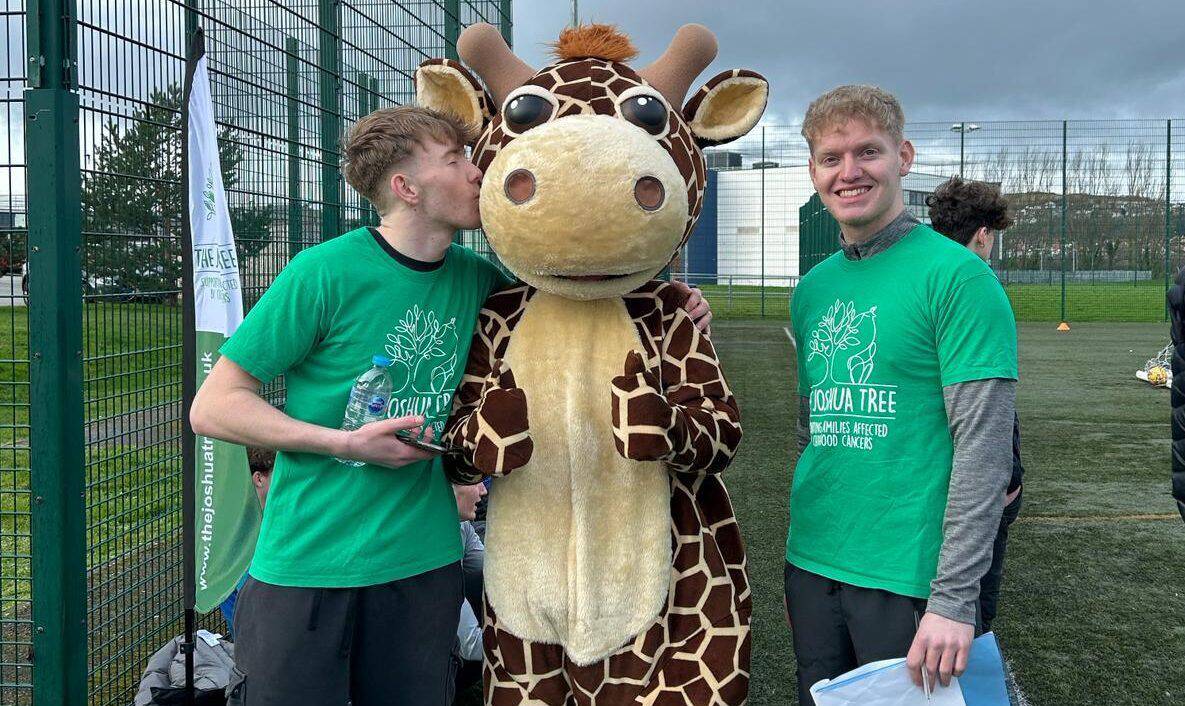 Coleg Llandrillo students with ‘Josh the Giraffe’, mascot of The Joshua Tree charity