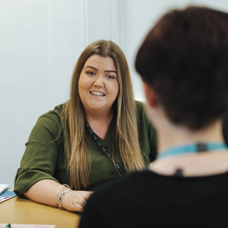 Member of staff helping student