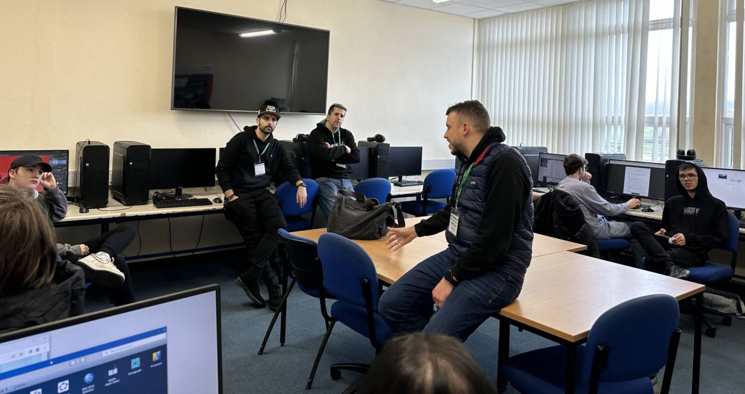 Games developers Mark Gregory, Stuart Ralphson and Modie Shakarchi talking to Coleg Llandrillo students